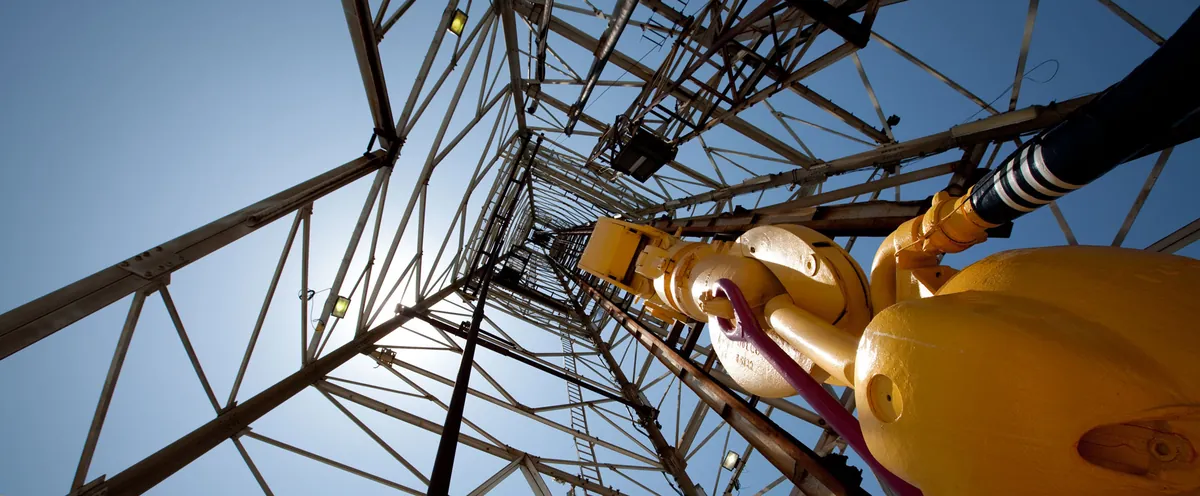 Looking up inside a rig derrick at the swivel