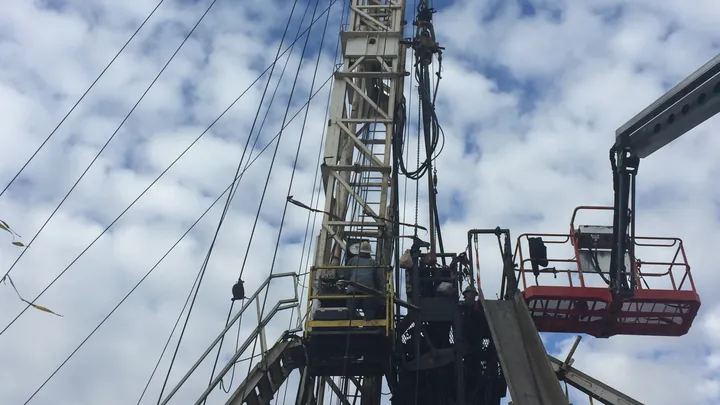 A Fortis workover rig with hands on the floor