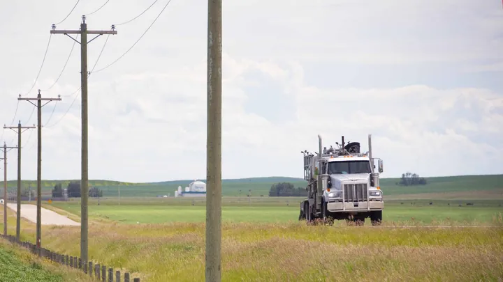 A Magnum bulk truck on a country road