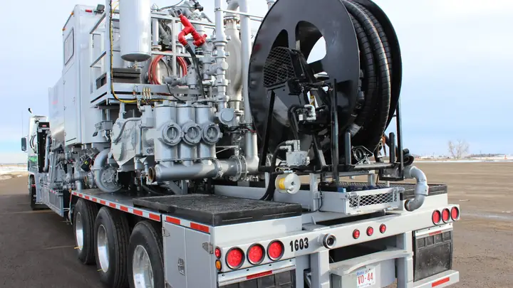 A Magnum cementing unit with its pump and hose reel