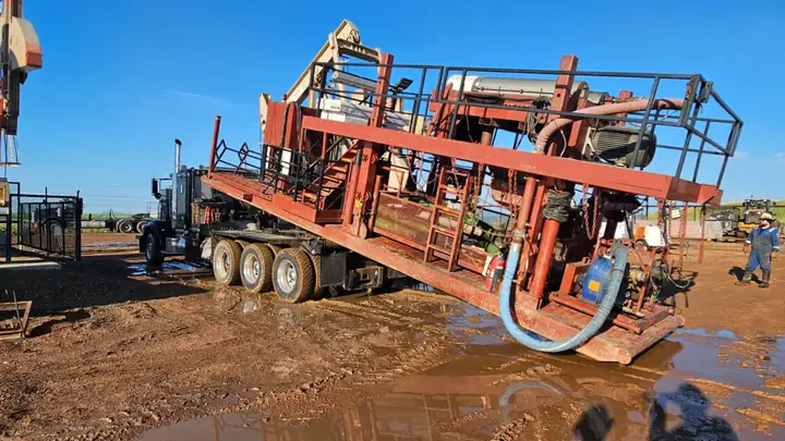 A North Point winch truck loading equipment on location