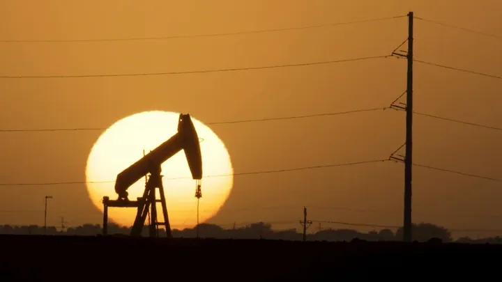 A pumpjack against the setting sun