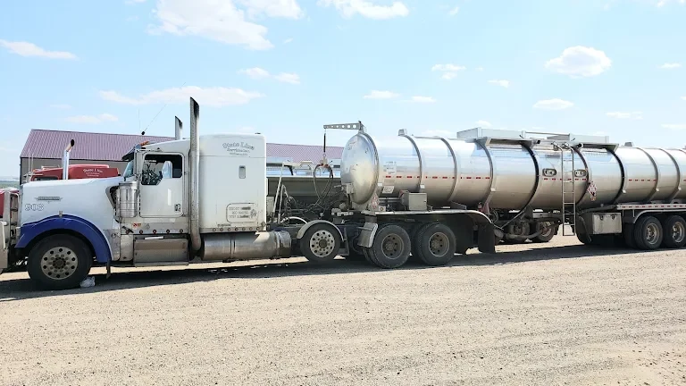A white StateLine truck hooked to a tank trailer