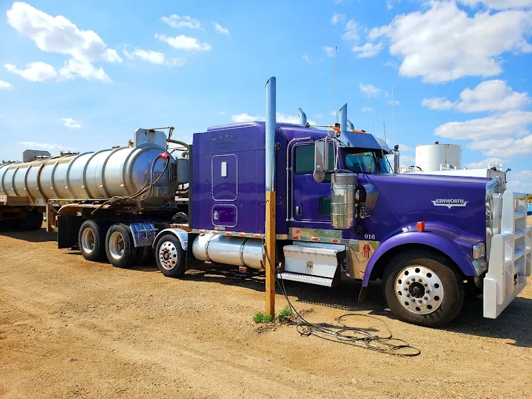 A purple StateLine truck hooked to a tank trailer